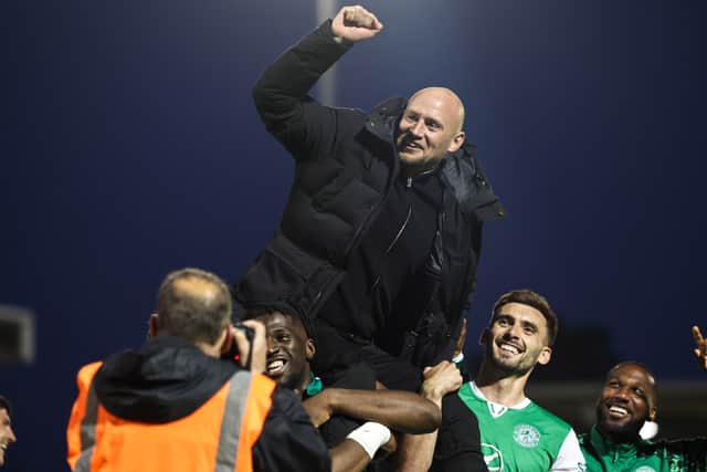 Hibs head coach David Gray celebrates with his players after clinching third place against St Mirren.