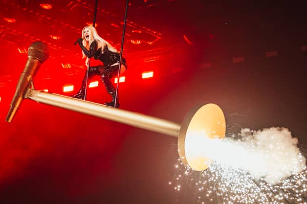 Why, yes. That is Finland's Erika Vikman flying across the Eurovision stage on a giant microphone. 