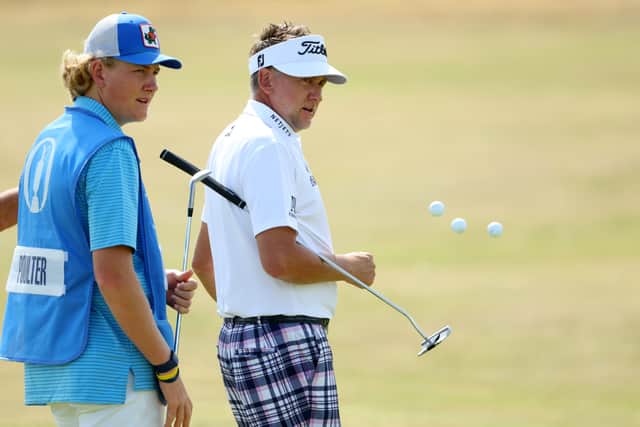 Luke Poulter pictured caddying for his dad Ian in  practice round prior to The 150th Open at St Andrews 