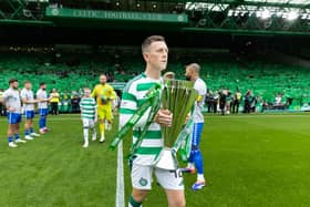 Celtic captain Callum McGregor carries the Premiership trophy on to the park ahead of the opening game of the season against Kilmarnock. (Photo by Craig Williamson / SNS Group)