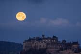 The moon sets behind Edinburgh Castle (Picture: Jane Barlow)