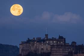 The moon sets behind Edinburgh Castle (Picture: Jane Barlow)