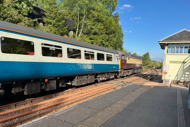 A Jacobite service hauled by a diesel locomotive passing Glenfinnan Station on May 14