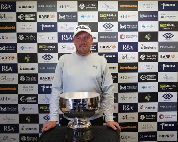 Englishman Mark Young shows off the trophy after winning the Montrose Links Masters presented by Montrose Port Authority