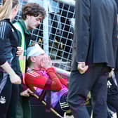 Aberdeen's Jack MacKenzie receives treatment after being hit with an object from the crowd at the end of the 2-1 defeat at Dundee United. (Photo by Roddy Scott / SNS Group)