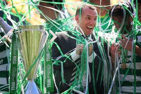 Celtic manager Brendan Rodgers is covered in ticker tape as he celebrates with the league trophy. (Photo by Ian MacNicol/Getty Images)