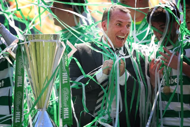 Celtic manager Brendan Rodgers is covered in ticker tape as he celebrates with the league trophy. (Photo by Ian MacNicol/Getty Images)