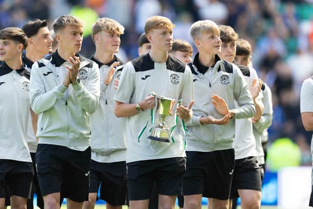 Hibs youngsters parade The Under-18s Elite League trophy during the half-time break of the 2-2 draw against Rangers. (Photo by Ross Parker / SNS Group)