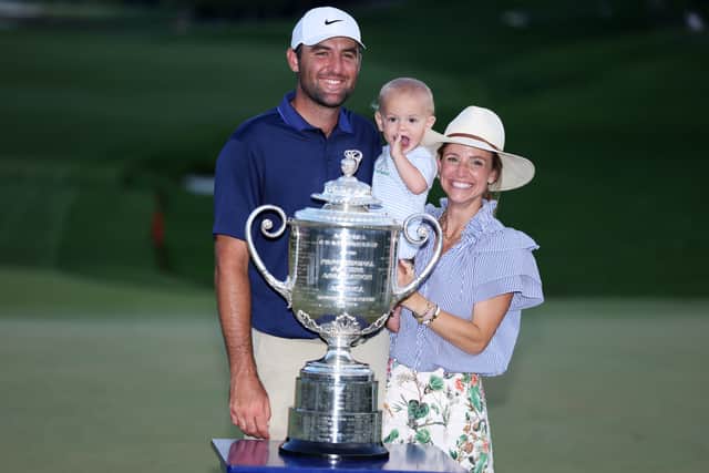 Scottie Scheffler poses with the Wanamaker Trophy with his wife Meredith and son Bennett after winning the 107th PGA Championship at Quail Hollow in Charlotte, North Carolina