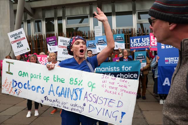 Campaigners from both sides of the argument demonstrate outside the Scottish Parliament (Picture: Jeff J Mitchell)