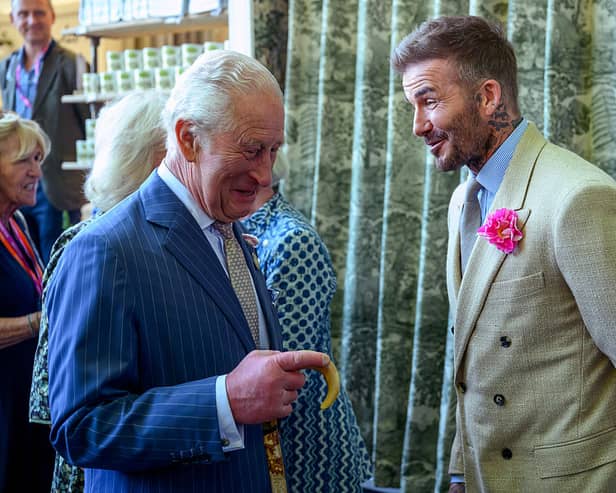 King Charles III chats to footballer David Beckham at the Chelsea Flower Show.