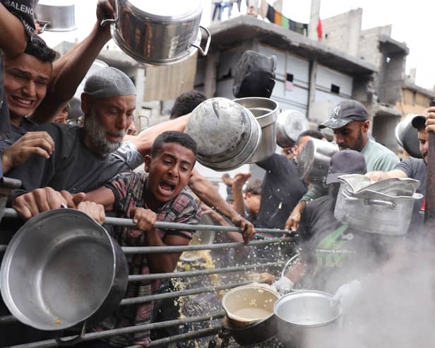 Palestinians struggle to get food rations outside a distribution centre in Beit Lahia in the northern Gaza Strip (Picture: Bashar Taleb)