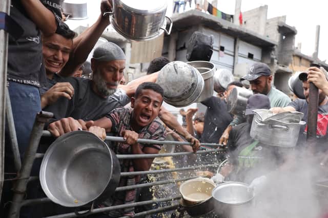 Palestinians struggle to get food rations outside a distribution centre in Beit Lahia in the northern Gaza Strip (Picture: Bashar Taleb)