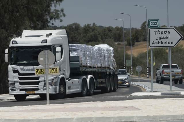 A truck loaded with humanitarian aid for the Gaza Strip makes its way to the Kerem Shalom crossing in southern Israel, in Israel-Gaza border on Tuesday