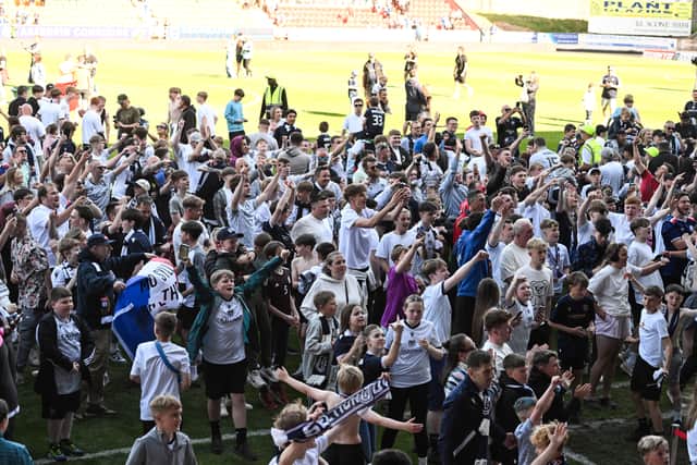 Dundee fans on the pitch at full time after the 2-0 win over St Johnstone which secured Premiership survival. (Photo by Paul Devlin / SNS Group)