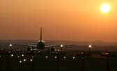 Aircraft taking off into the sunset at Edinburgh Airport