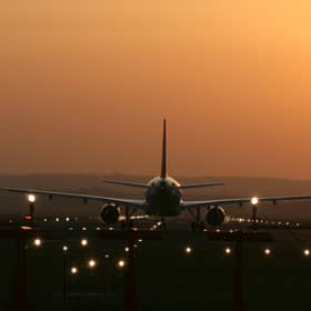Aircraft taking off into the sunset at Edinburgh Airport