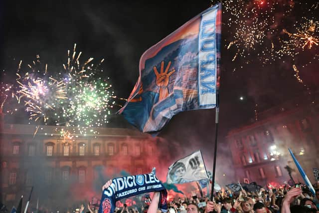 Fireworks fill the sky as Napoli supporters celebrate winning the Serie A title at Piazza del Plebiscito in Naples. (Photo by ALBERTO PIZZOLI/AFP via Getty Images)