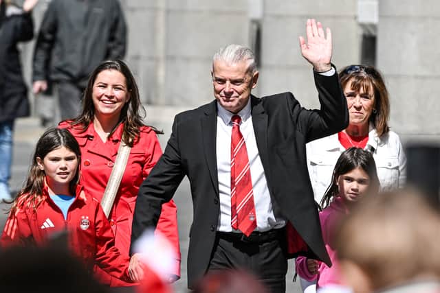Aberdeen chairman Dave Cormack waves to supporters.