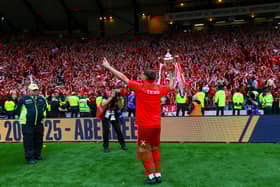 Aberdeen captain Graeme Shinnie shows off the Scottish Cup to the Aberdeen fans.