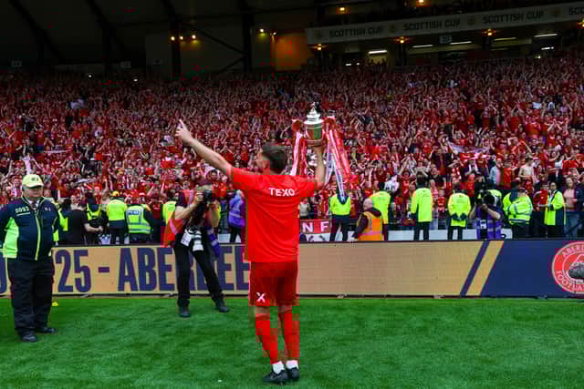 Aberdeen captain Graeme Shinnie shows off the Scottish Cup to the Aberdeen fans.
