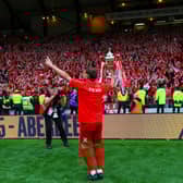 Aberdeen captain Graeme Shinnie shows off the Scottish Cup to the Aberdeen fans.