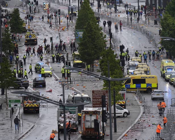 Police and emergency personnel dealing with a road traffic incident on Water Street near the Liver Building in Liverpool after a car collided with pedestrians during the Premier League winners' parade