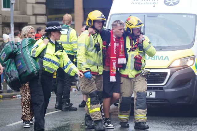 Police and emergency personnel dealing with a road traffic incident on Water Street near the Liver Building in Liverpool after a car collided with pedestrians during the Premier League winners' parade