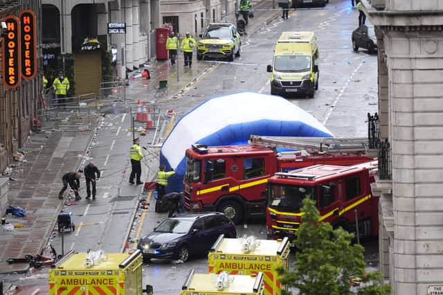 A tent is erected by police with a road traffic accident on Water Street near the Liver Building in Liverpool after a car collided with pedestrians during the Premier League winners' parade