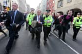 Nigel Farage (centre) on the Royal Mile being escorted by police officers as he leaves the Canons' Gait pub in 2013, while Ukip leader. Protestors heckled him during his visit to Edinburgh.