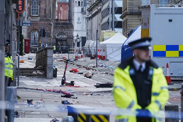 Police tents surrounded by debris at the scene in Water Street near the Liver Building in Liverpool city centre after a 53-year-old white British man was arrested when a car ploughed into a crowd of people during Liverpool FC's Premier League victory parade. Picture: Peter Byrne/PA Wire