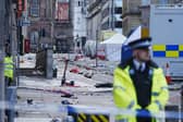 Police tents surrounded by debris at the scene in Water Street near the Liver Building in Liverpool city centre after a 53-year-old white British man was arrested when a car ploughed into a crowd of people during Liverpool FC's Premier League victory parade. Picture: Peter Byrne/PA Wire