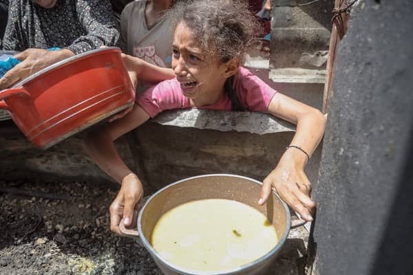 A girl appears to be in distress after receiving food at Jabalia refugee camp, Gaza City, earlier this month (Picture: Abood Abusalama)