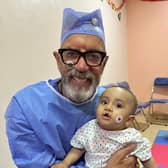 Dragons Den star Duncan Bannatyne with eight-month-old Zyad, who was heading into surgery for a cleft palette operation
