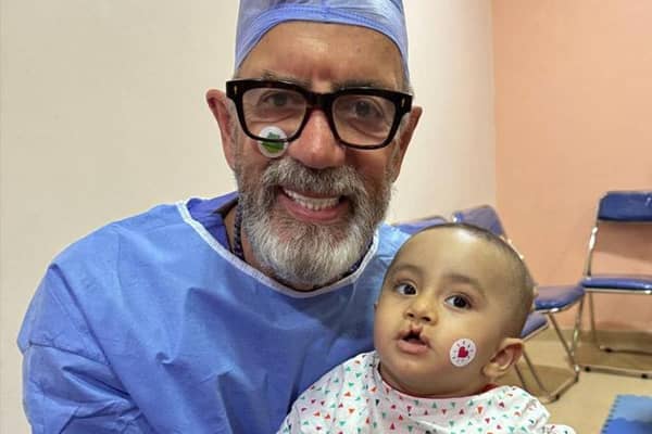 Dragons Den star Duncan Bannatyne with eight-month-old Zyad, who was heading into surgery for a cleft palette operation