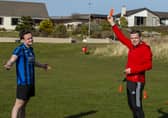 Former Scottish Conservatives leader Douglas Ross, showing a red card
