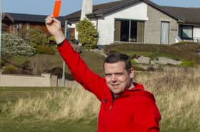 Former Scottish Conservatives leader Douglas Ross, showing a red card