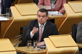 Douglas Ross points something out in the Scottish Parliament chamber (Picture: Jeff J Mitchell)