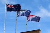 A New Zealand flag, left, flies alongside two suggested replacements (Picture: Fiona Goodall)