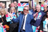 Reform UK leader Nigel Farage poses outside a pub in Morpeth, Northumberland, on the local election campaign trail in April