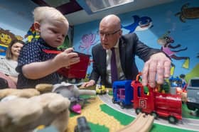 First Minister John Swinney with Rory Lees, aged 2, during a visit to Juniors Charity in Hamilton, Lanarkshire, while on the campaign trail ahead of the upcoming Hamilton, Larkhall and Stonehouse by-election on Thursday