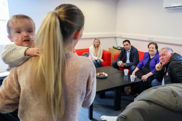 Tammy Johnstone holds three year old Kai as Scottish Labour leader Anas Sarwar, deputy Jackie Ballie and candidate Davy Russell meet with parents and Wishaw neonatal campaigners (Photo by Jeff J Mitchell/Getty Images)