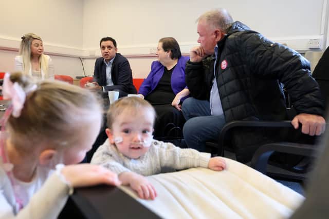 Children Erin McLay and Kai Johnstone play as Scottish Labour leader Anas Sarwar, deputy Jackie Ballie and candidate Davy Russell meet with local parents including Amanda Todd (left) raising concerns about the potential downgrade of services at Wishaw General Hospital (Photo by Jeff J Mitchell/Getty Images)