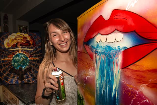 Omani Hamer with her fridge mural. Photo credit: Lucinda Herbert
