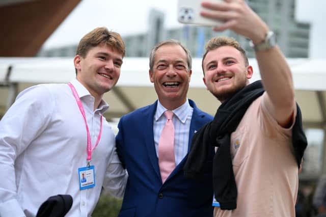 Delegates at the Conservative party conference in 2023 pose for a photograph with Nigel Farage (Picture: Oli Scarff)
