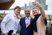 Delegates at the Conservative party conference in 2023 pose for a photograph with Nigel Farage (Picture: Oli Scarff)