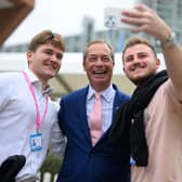 Delegates at the Conservative party conference in 2023 pose for a photograph with Nigel Farage (Picture: Oli Scarff)