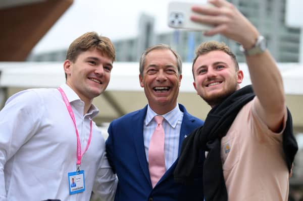 Delegates at the Conservative party conference in 2023 pose for a photograph with Nigel Farage (Picture: Oli Scarff)