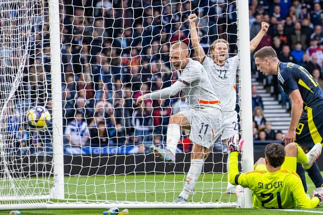 Iceland's Jon Dagur Thorsteinsson (L) celebrates as Scotland's Lewis Ferguson (R) scores an own goal. (Photo by Alan Harvey / SNS Group)