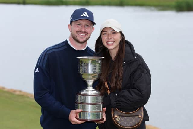 New KLM Open champion Connor Syme shows off the trophy with his wife Alanis, who had flown in to watch the final round at The International